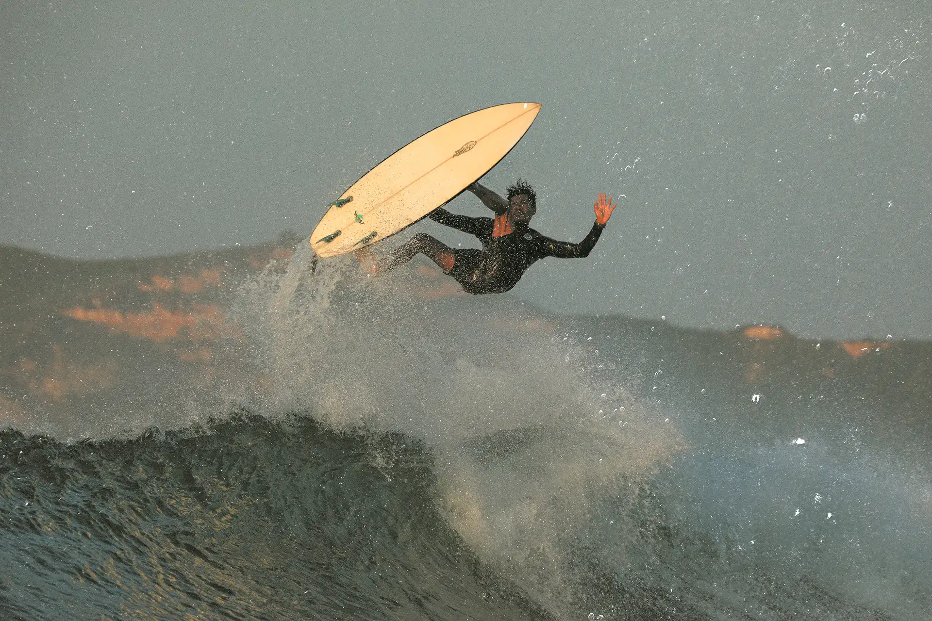 Calon in the air above a wave, in the vintage treatment