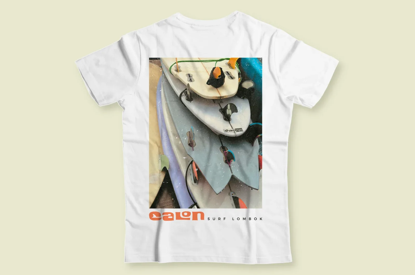 The back of a white Calon Surf T-shirt, with the treated photo of the boards and the logo
