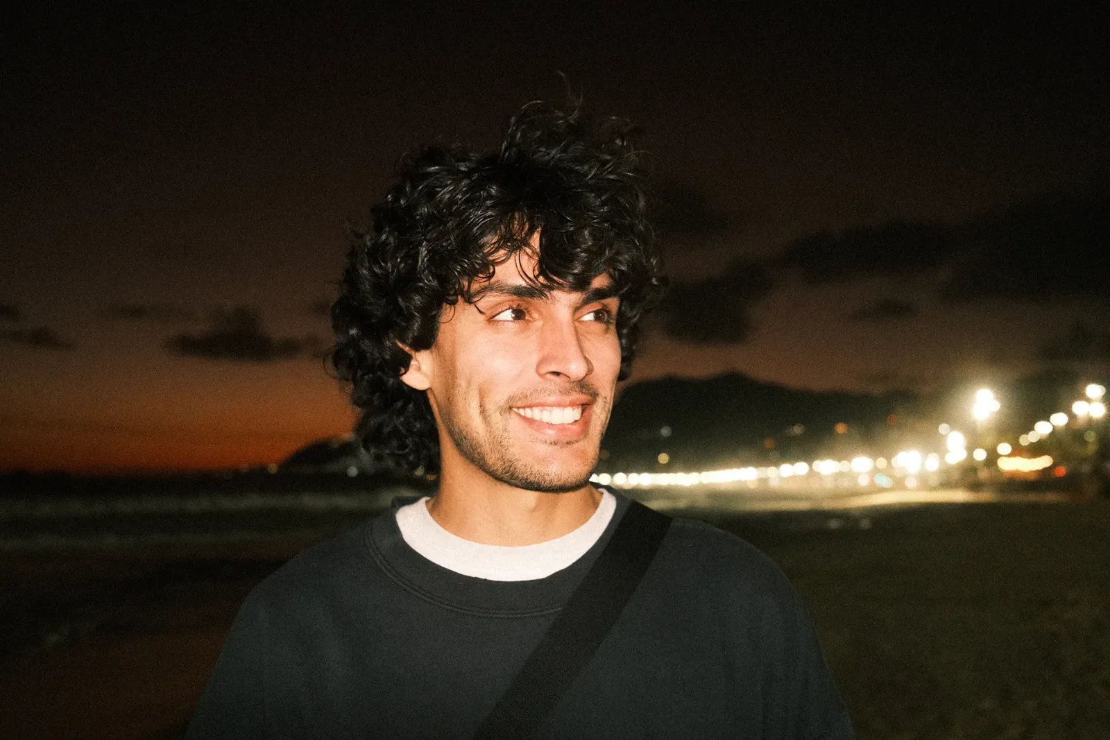Lucas Cubillos Mialani, founder of Cubilani, smiling outdoors at night